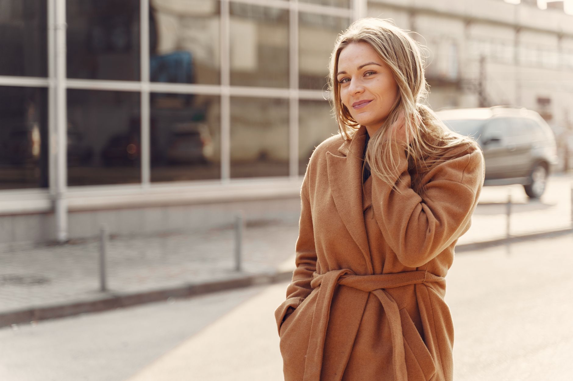 A woman wearing an autumn coat outdoors