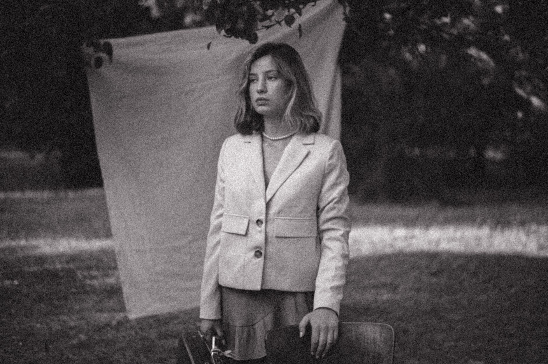 A woman in a fitted blazer buttoned once