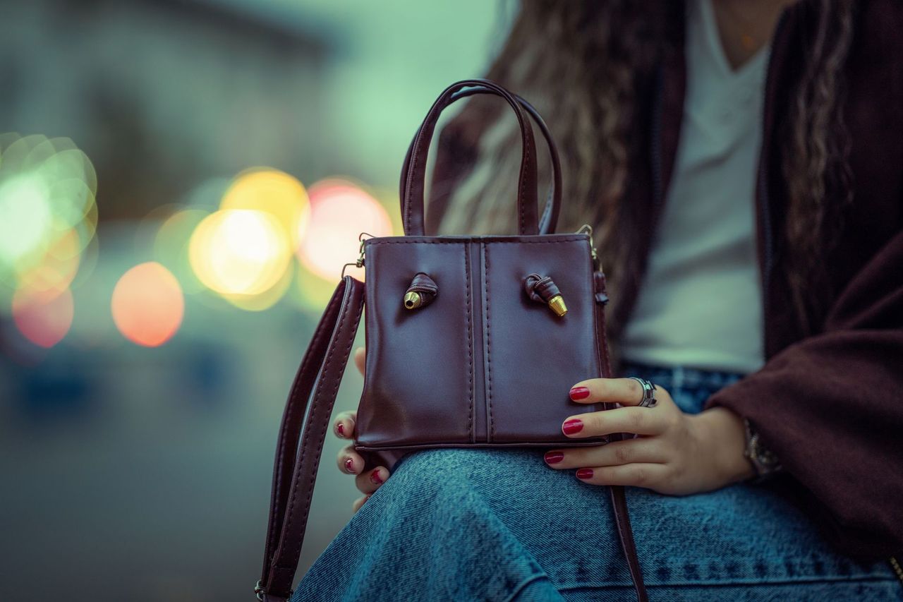 A burgundy leather handbag in editorial styling