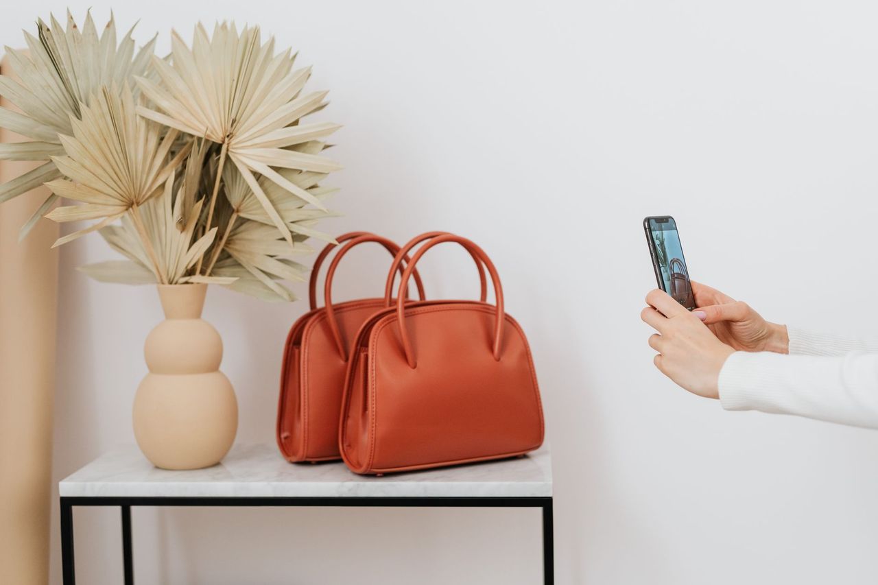 Structured leather tote in caramel photographed against a stone surface