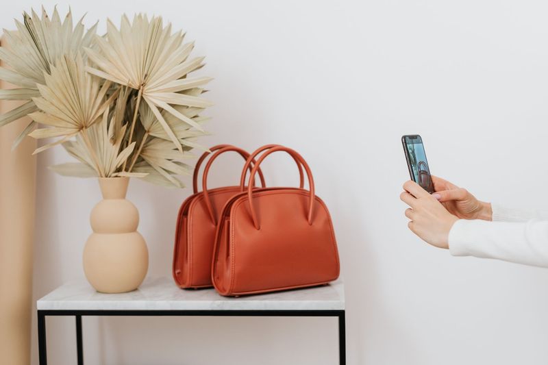 Structured leather tote in caramel photographed against a stone surface
