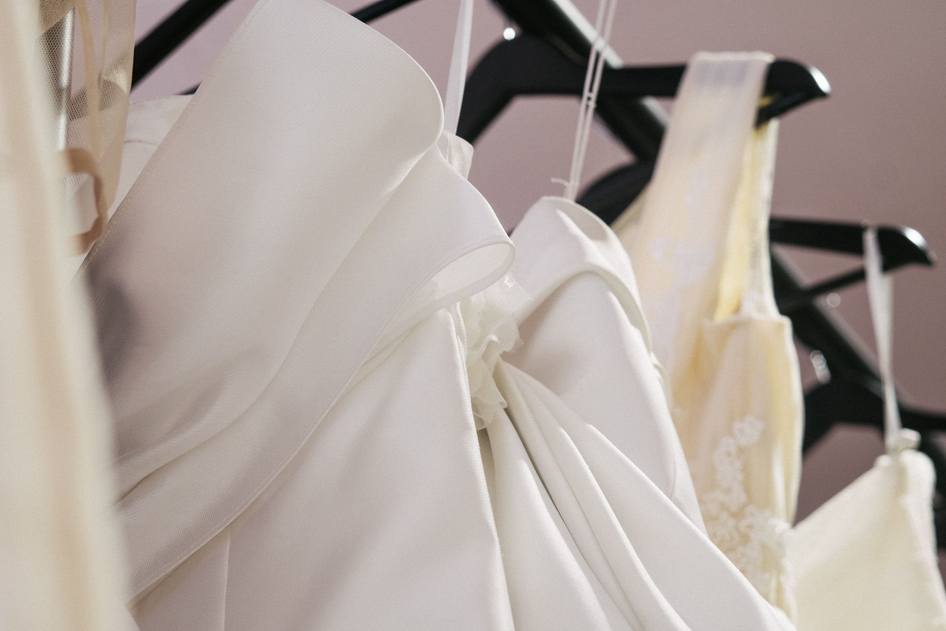 A satin evening slip dress on a hanger