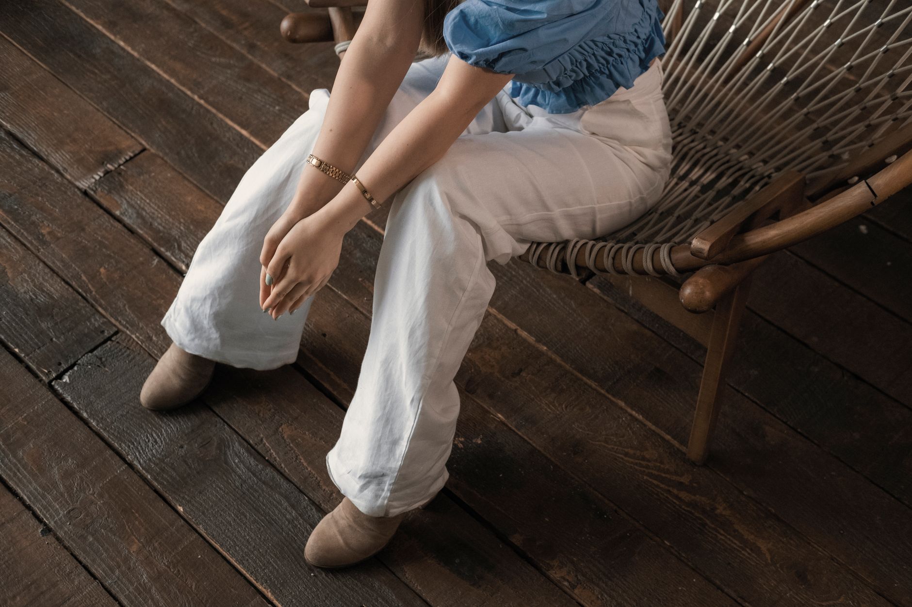 A cashmere sweater and trousers on a chair