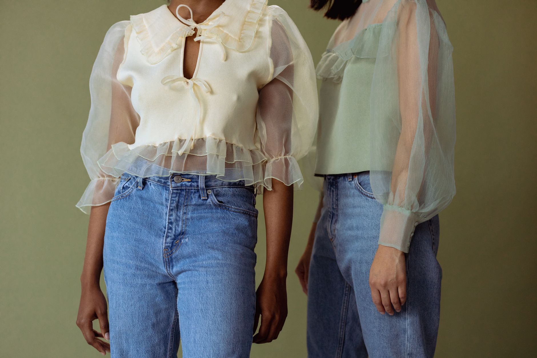 A sheer top layered over a slip camisole