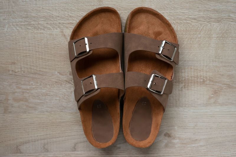 A pair of suede loafers on a wood floor