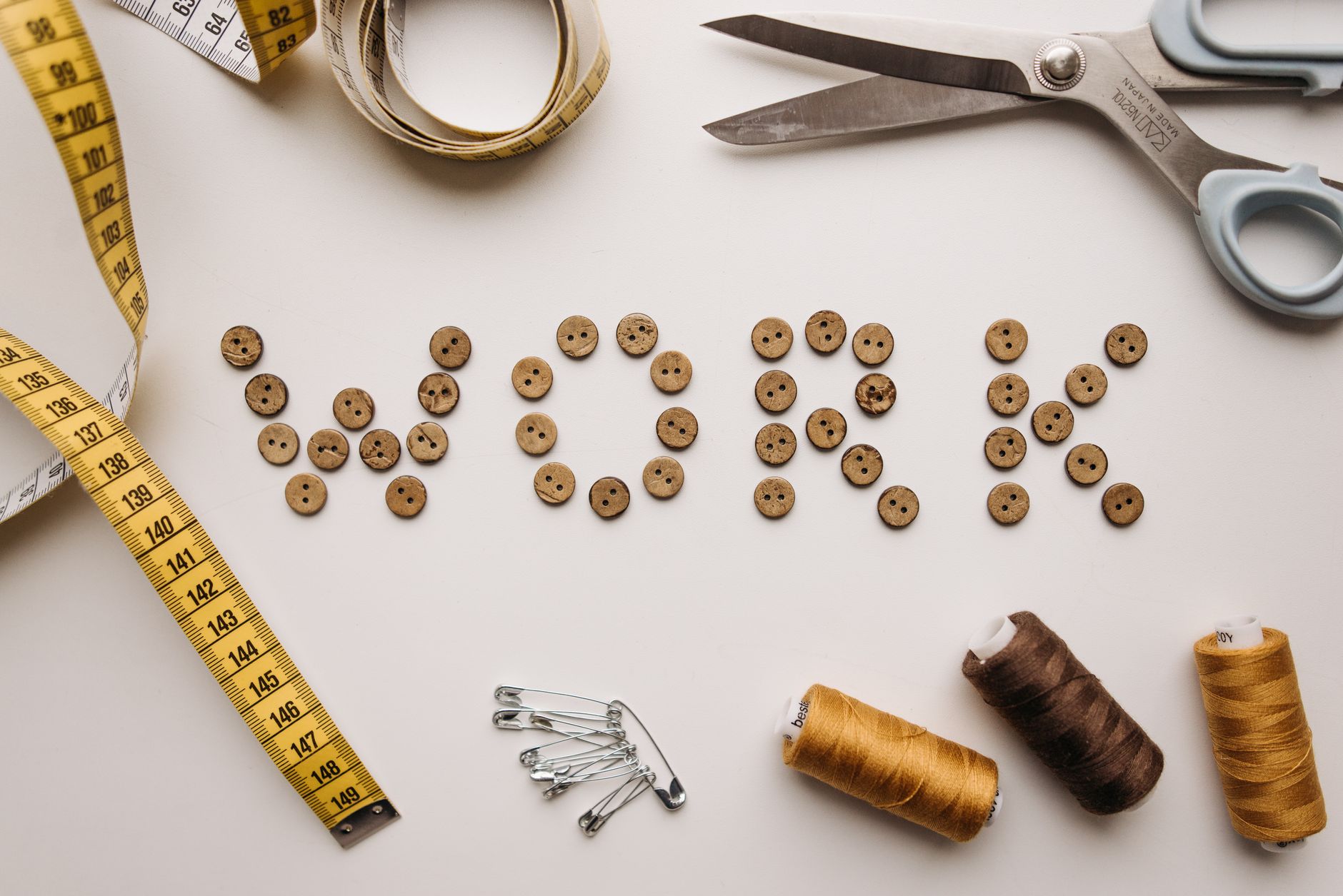 Sewing supplies and buttons on a workshop table
