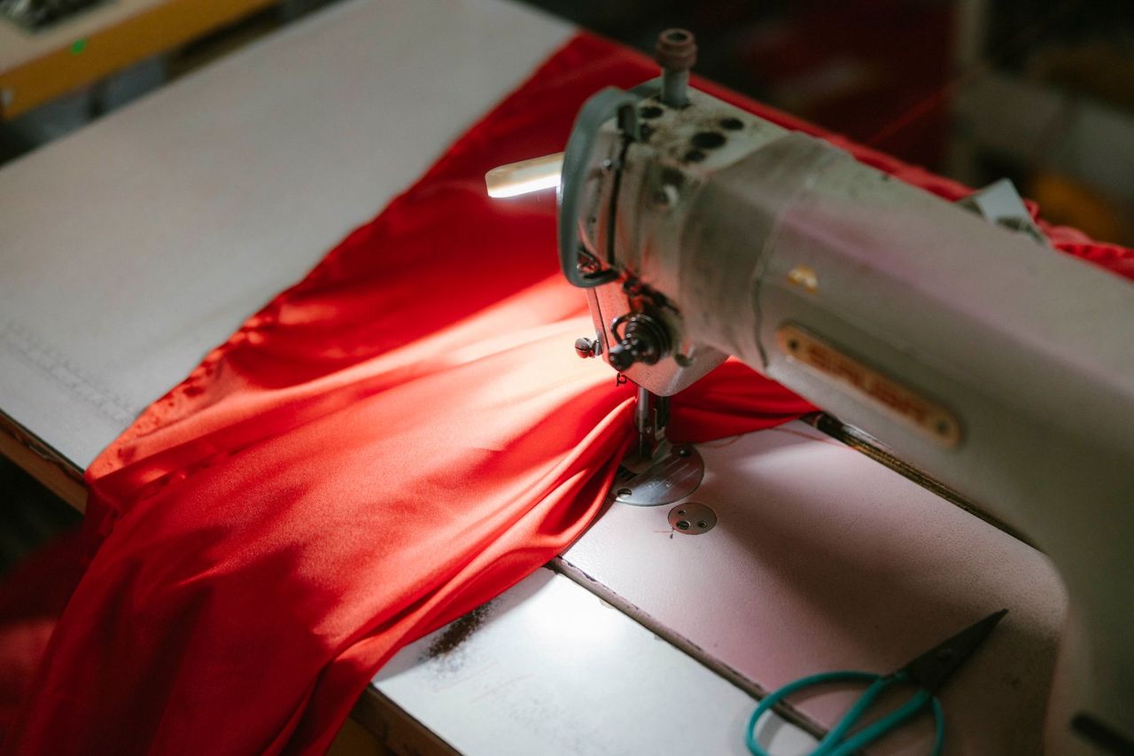 A tailor working on a garment in a workshop