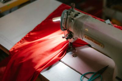 A tailor working on a garment in a workshop