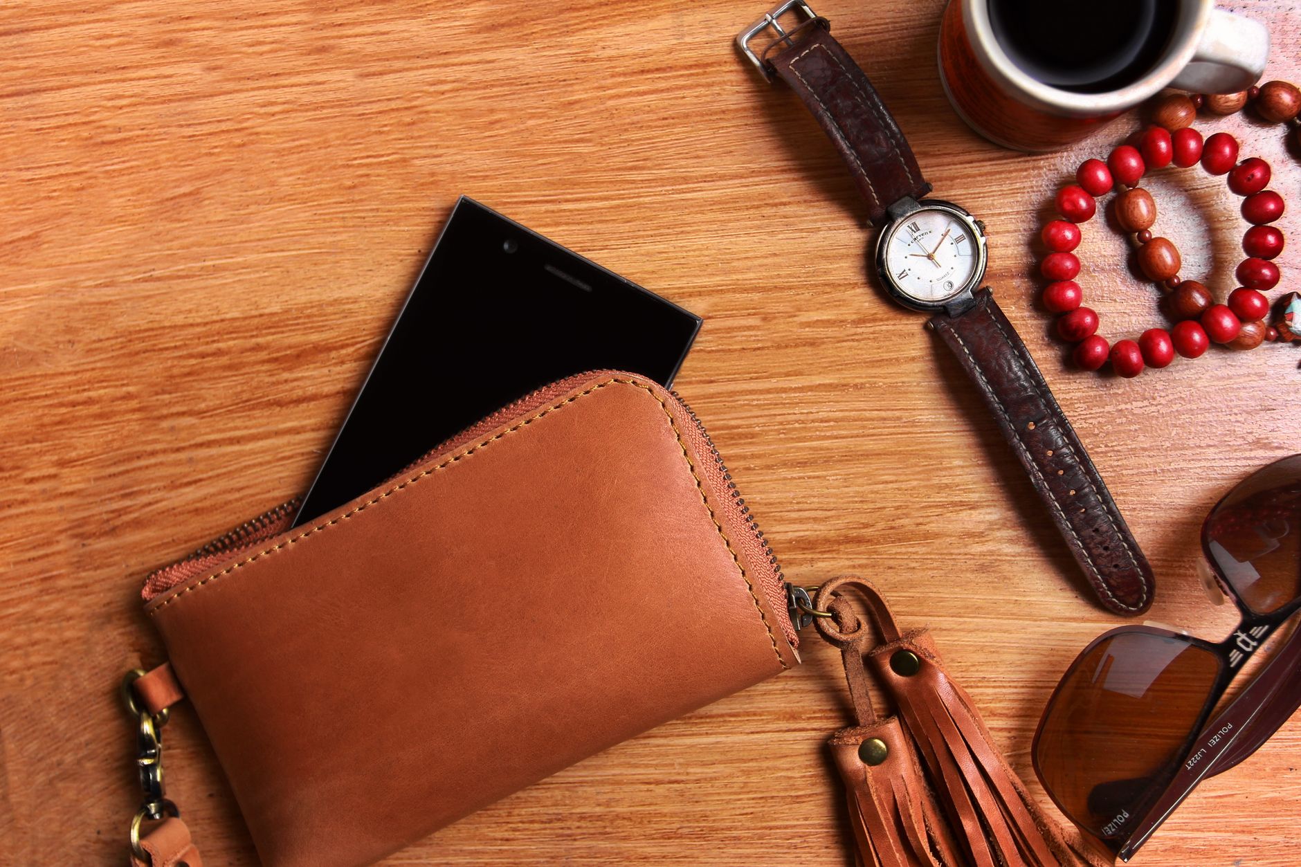 A minimal leather handbag on a cafe table