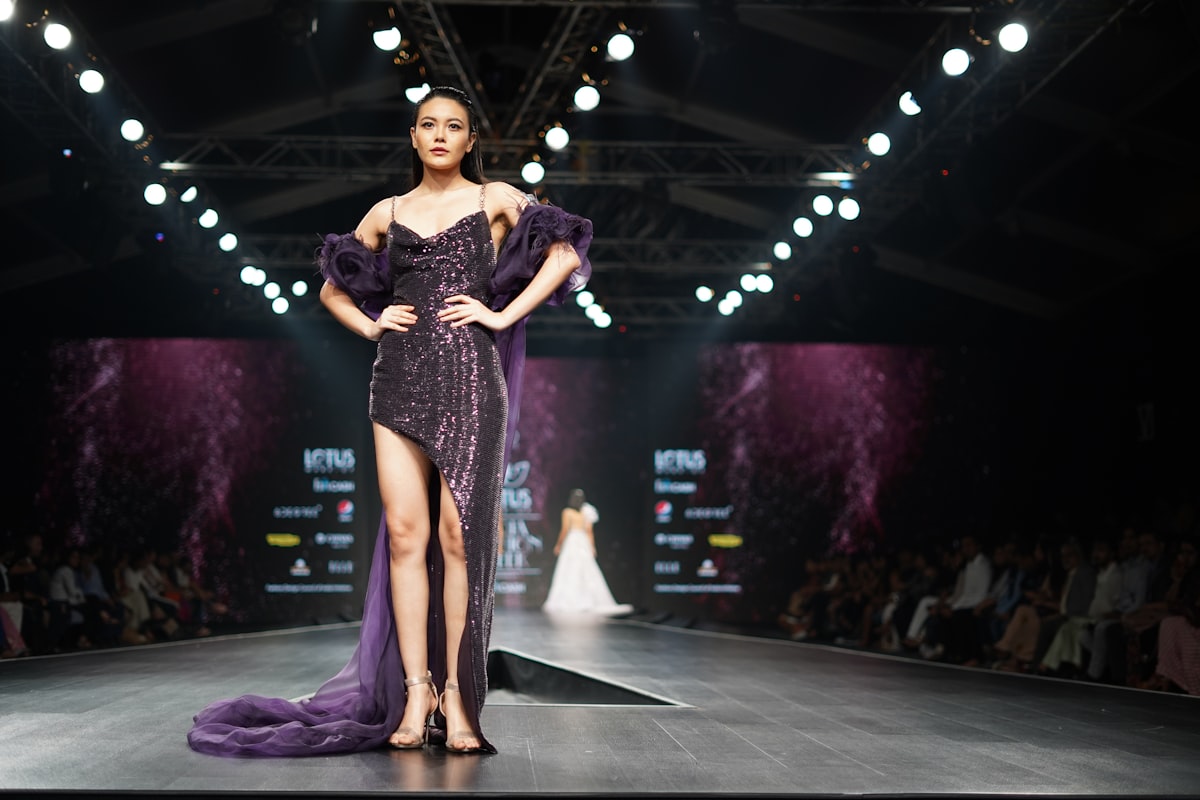 Designer purple gown on fashion runway at fashion week