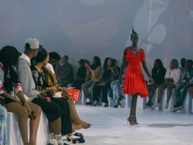 Elegant fashion runway model walking in a designer sheer gown at fashion week